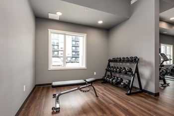 room with gym equipment and a window in the corner